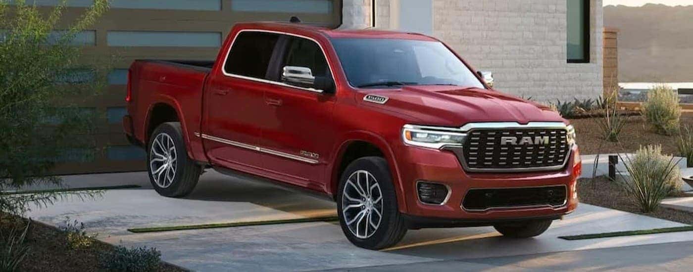 A red 2026 Ram 1500 parked on a driveway.
