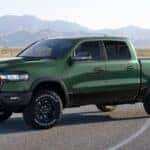 Green 2026 Ram 1500 parked in the road at an angle.