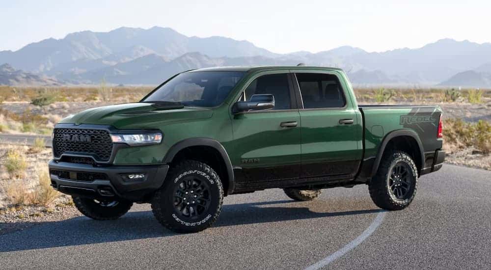 Green 2026 Ram 1500 Rebel parked in the road at an angle.