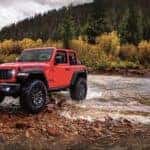 Red 2025 Jeep Wrangler Rubicon for sale near Alexandria driving through a river