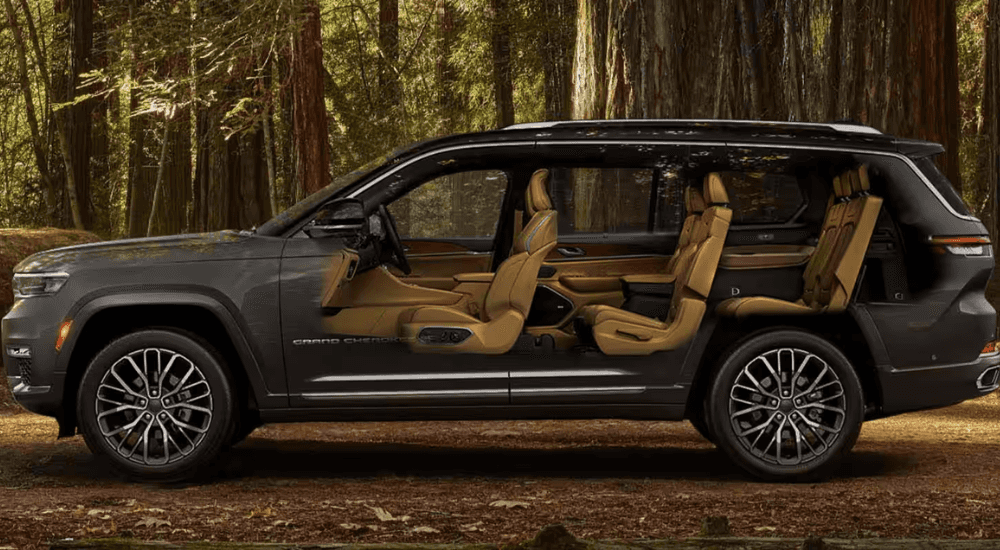 Brown 2025 Jeep Grand Cherokee L parked in the woods showing all three rows