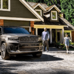 A father and daughter walk up to their 2025 Jeep Grand Cherokee Altitude X