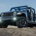 A blue 2026 Jeep Gladiator Rubicon parked on a hill.