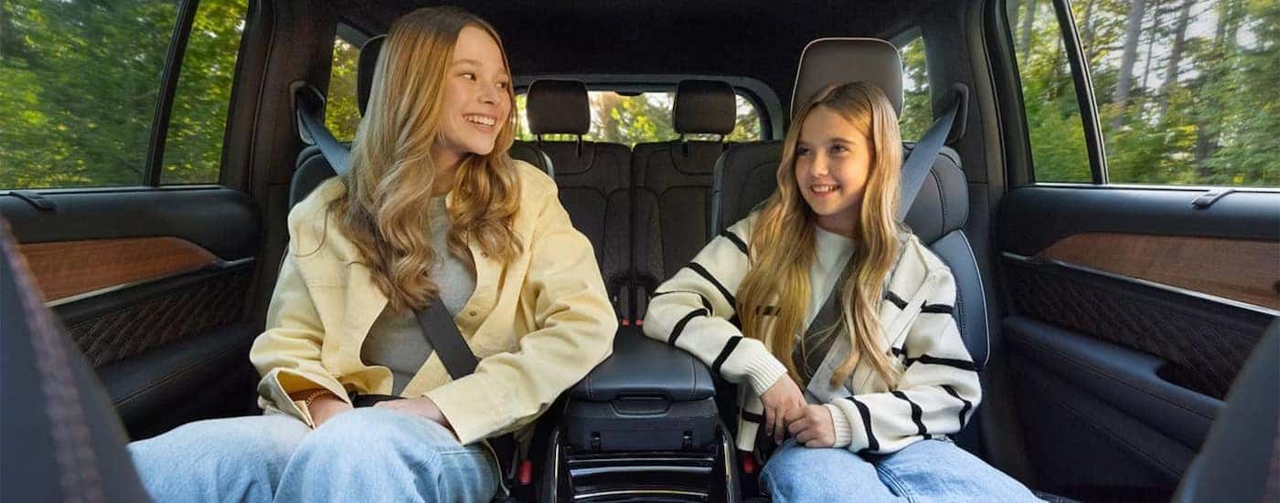 Two children in the rear seating area of a 2026 Jeep Grand Cherokee.