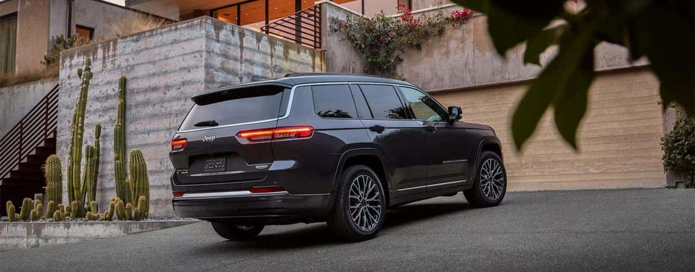 A gray 2026 Jeep Grand Cherokee parked on a driveway.