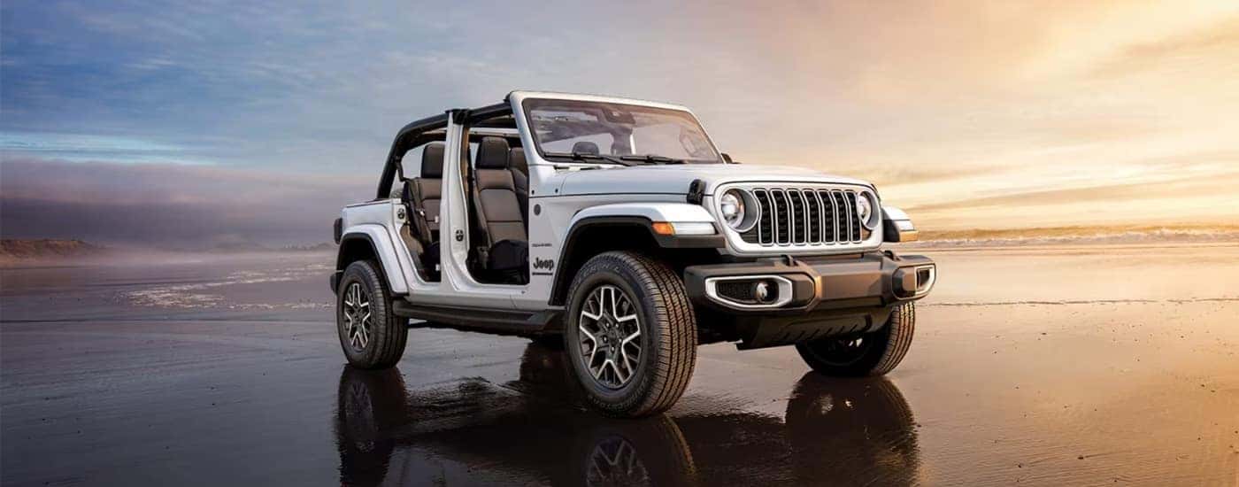 A white 2025 Jeep Wrangler from the side after leaving a Jeep dealer in Norwood.