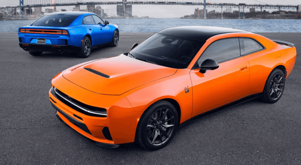 An orange and a blue 2026 Dodge Chargers pair next to each other