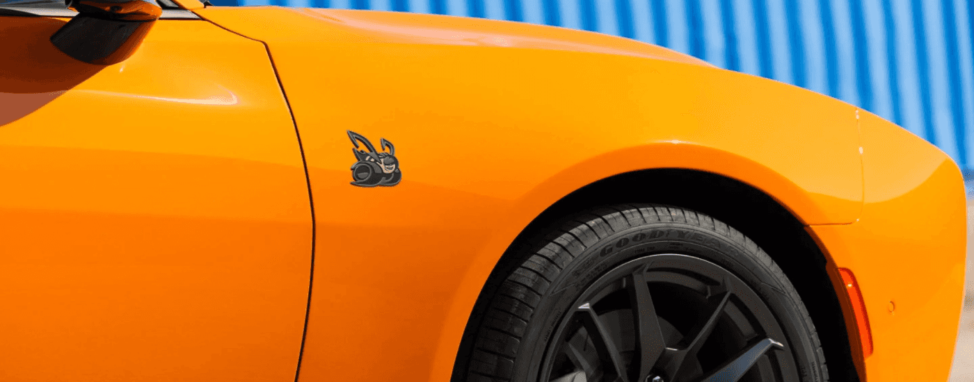 Front scatpact badging on an orange 2026 Dodge Charger