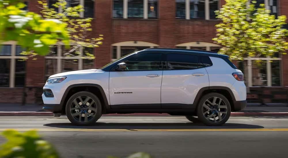 Silver 2026 Jeep Compass driving to a Jeep dealer near Norwood