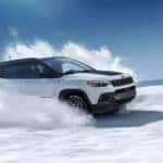 White 2026 Jeep Compass Trailhawk kicking up snow