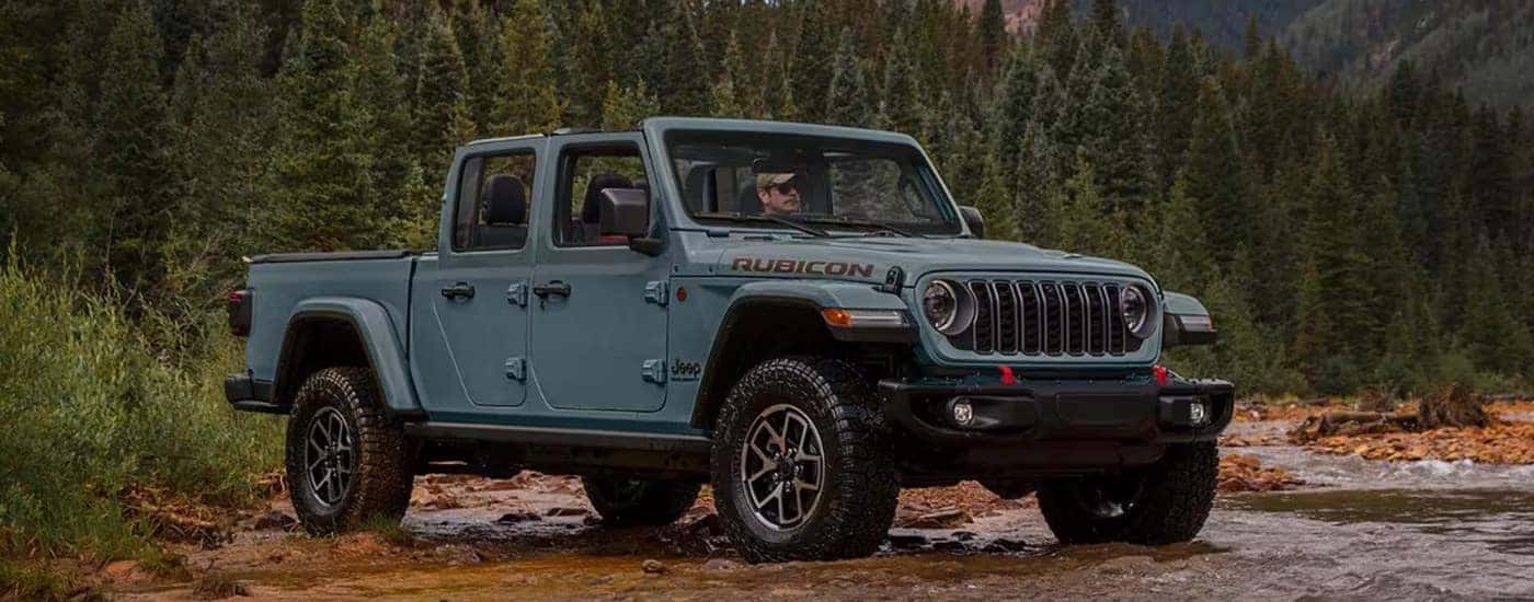 A grey 2025 Jeep Gladiator from the front at an angle.