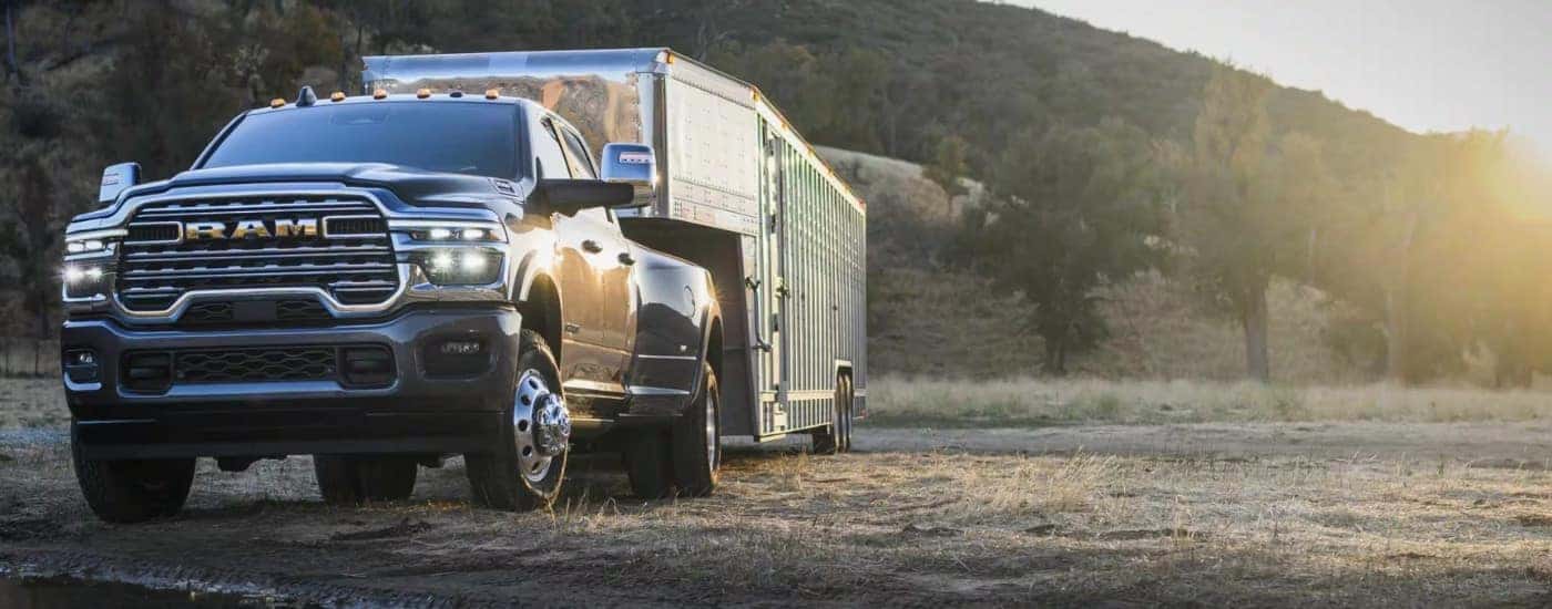 Grey 2026 Ram 3500 towing a trailer to a Ram dealer near Cincinnati