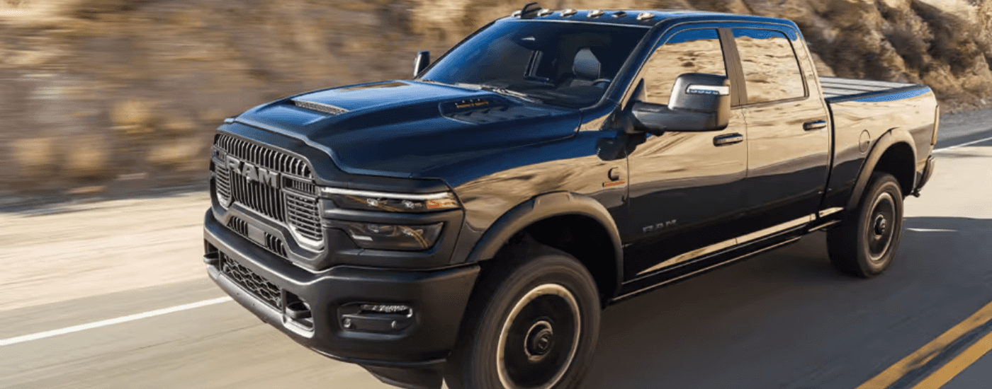 Black 2026 Ram 2500 driving down the road