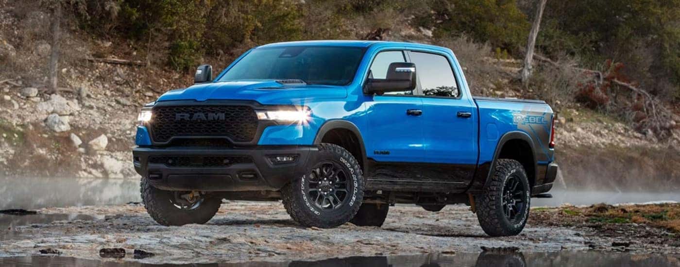 A blue 2025 Ram 1500 from the side.