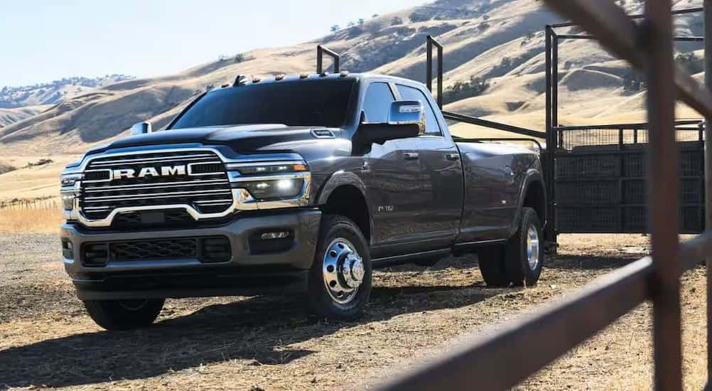 A gray 2026 Ram 3500 parked near a hill.