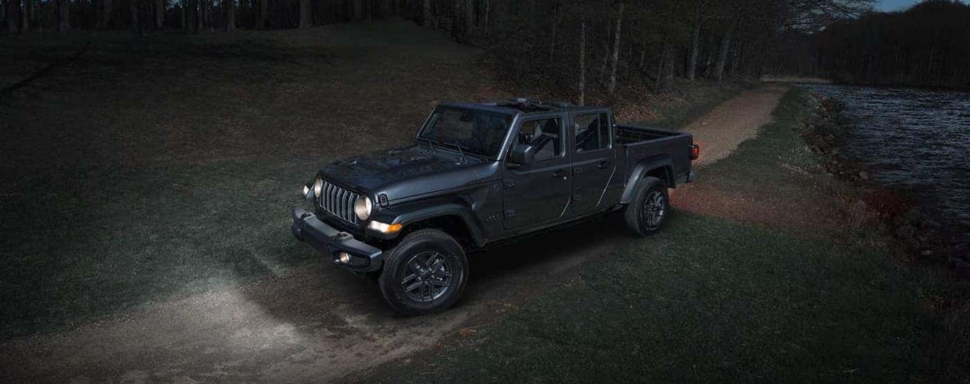 A gray 2026 Jeep Gladiator parked at night.