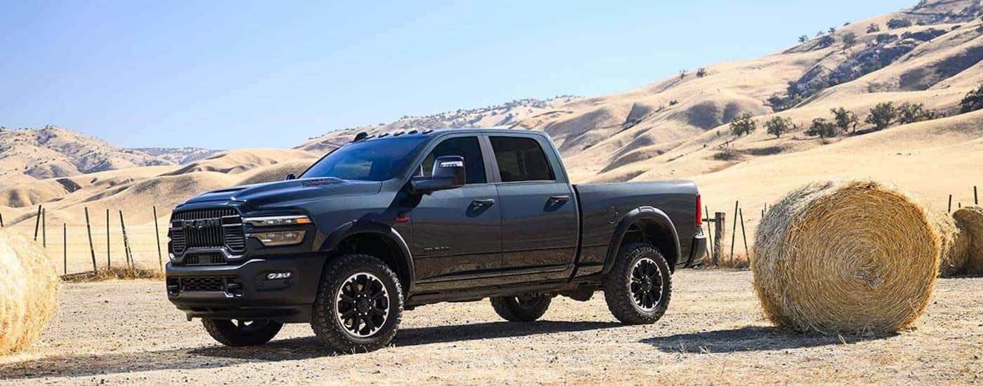 Side of a grey 2025 Ram 2500 parked off-road.