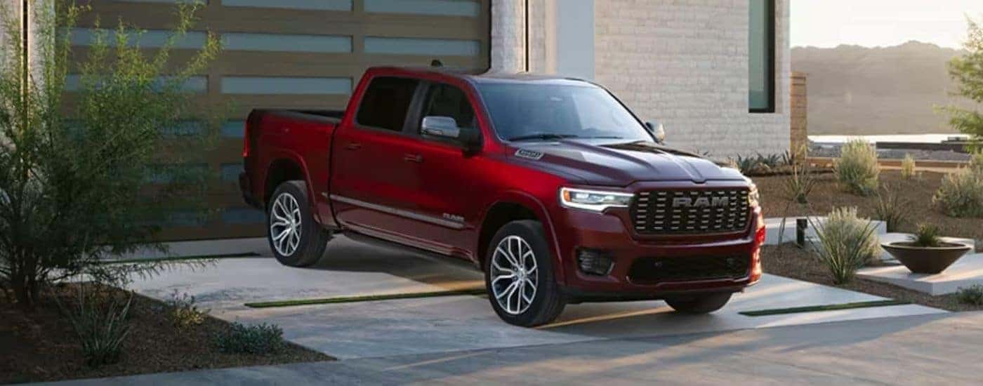 A red 2025 Ram 1500 parked from a dealer near Brookville