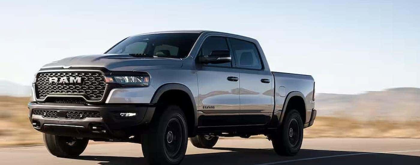 A silver Ram 1500 driving down a highway