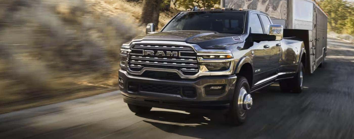 A black 2026 Ram 3500 towing a trailer