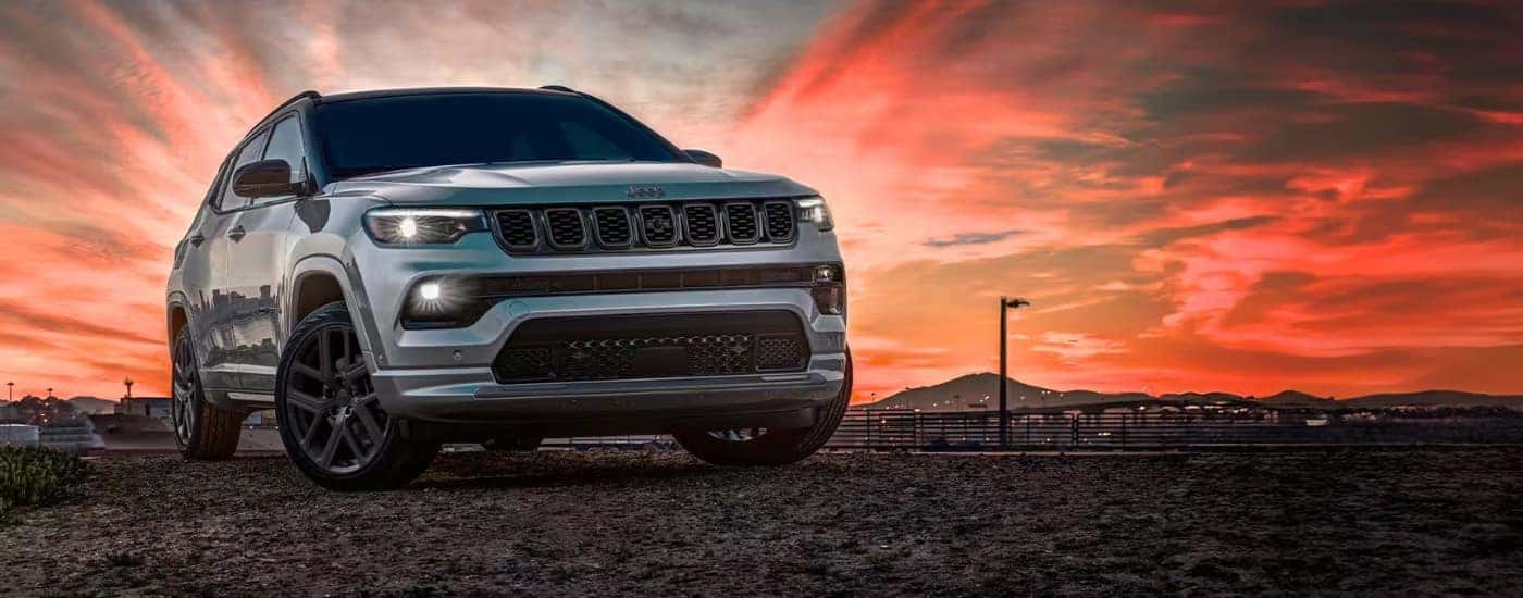 Silver 2025 Jeep Compass parked at sunset