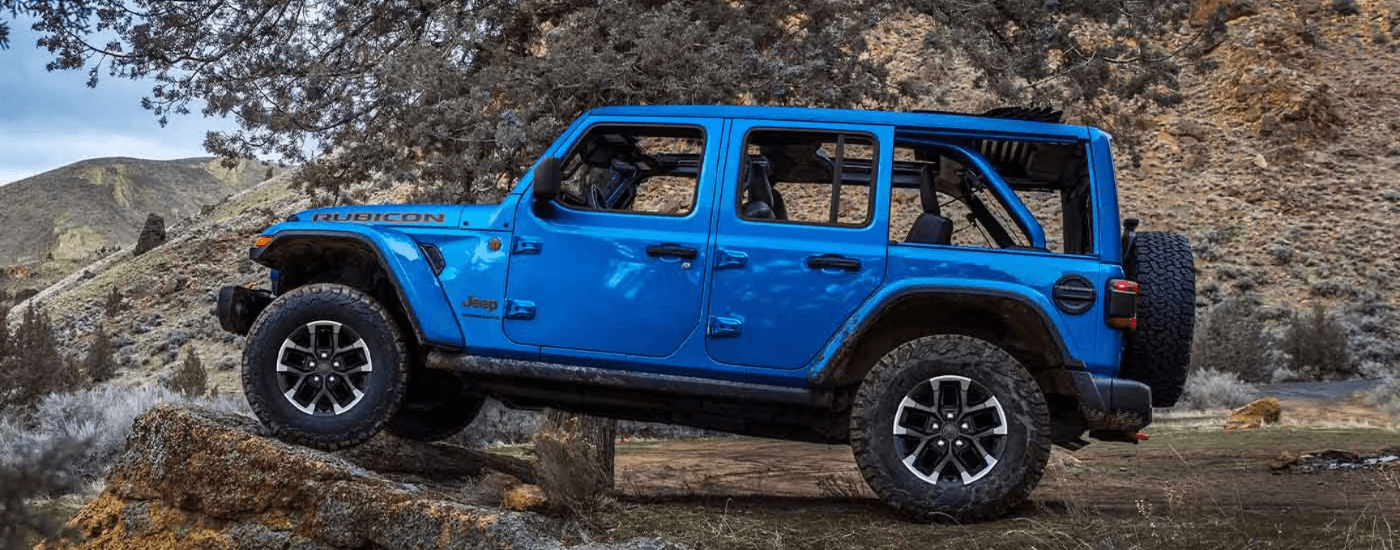Blue 2026 Jeep Wrangler parked on a rock