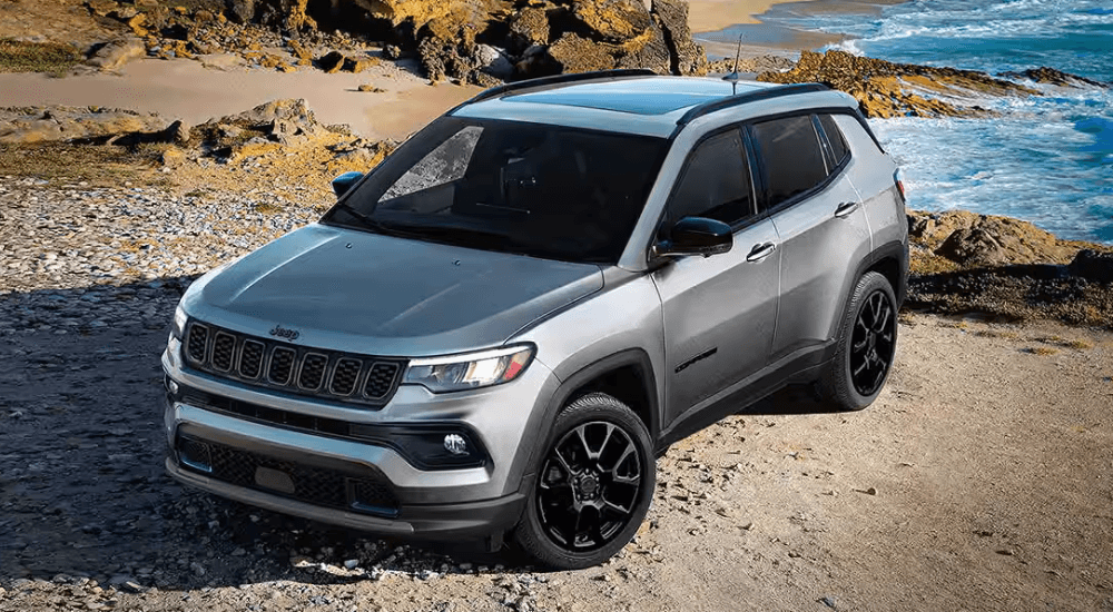 Silver 2026 Jeep Compass Latitude Altitude parked by the sea