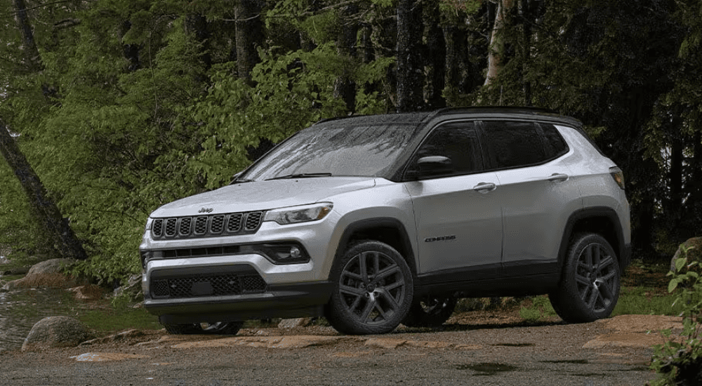 Silver 2026 Jeep Compass Latitude Altitude parked in the woods