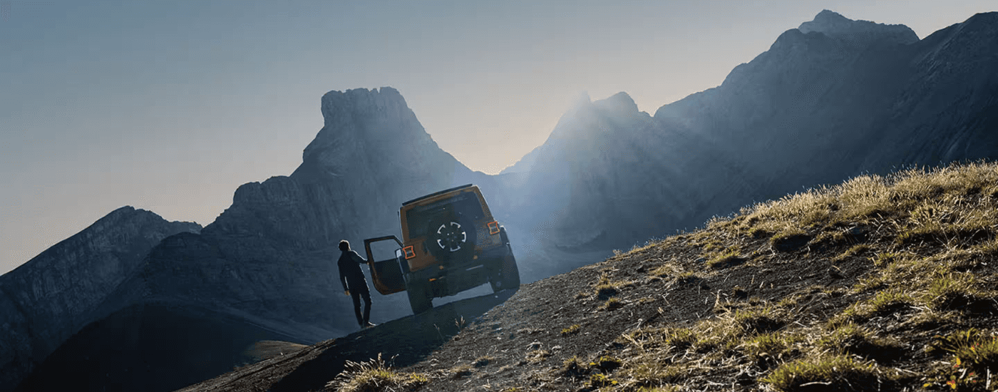 Red 2026 Jeep Wrangler parked on a steep incline