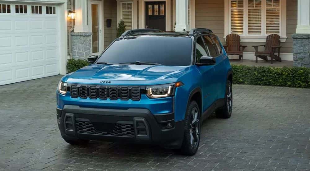 Blue 2026 Jeep Cherokee parked in a driveway