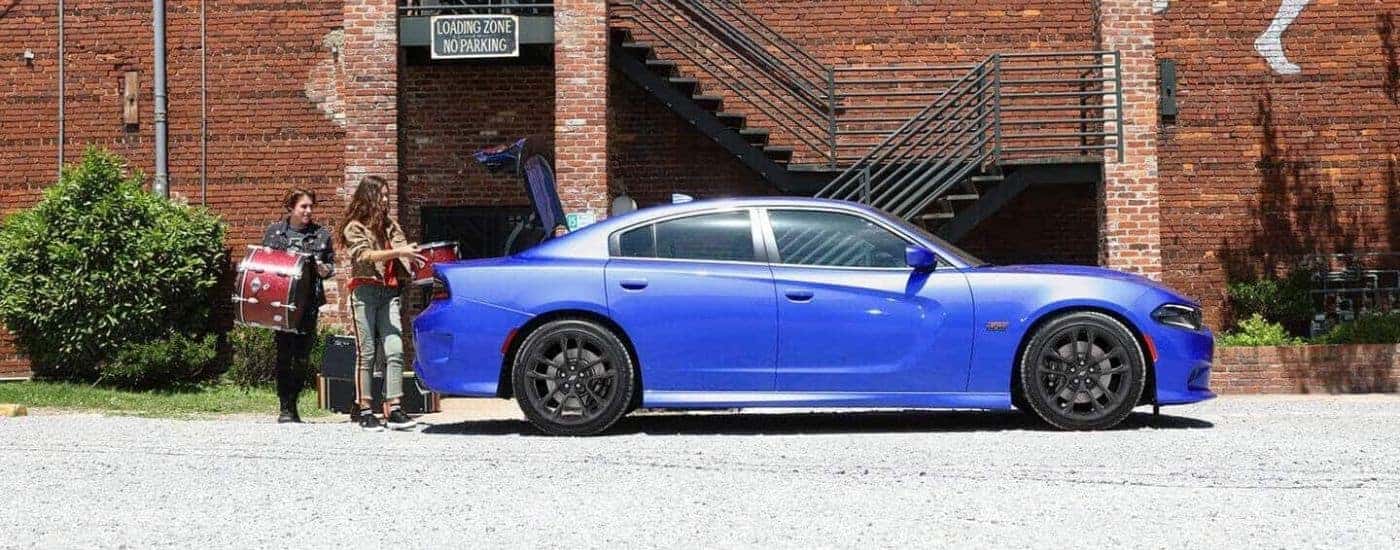 Blue 2020 Dodge Charger parked against a brick building