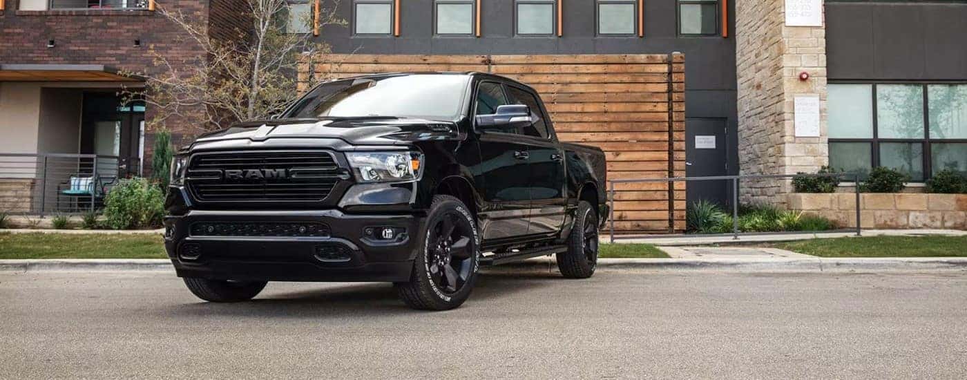 Black 2020 Ram 1500 parked in front of a building