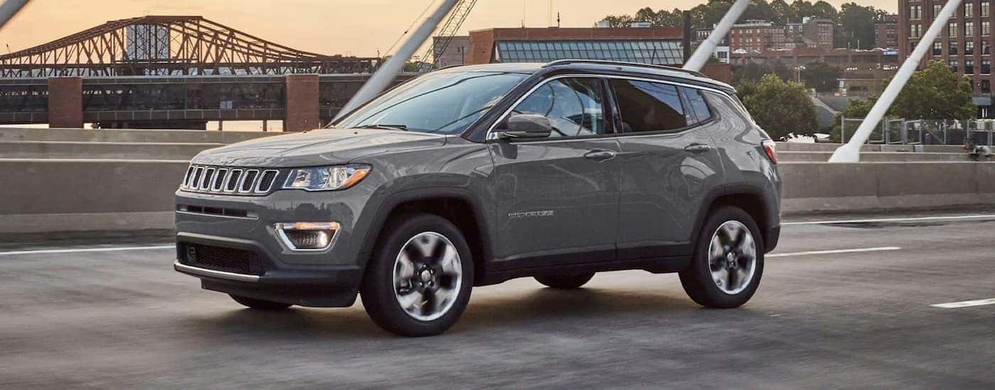 Grey 2021 Jeep Compass driving down the road