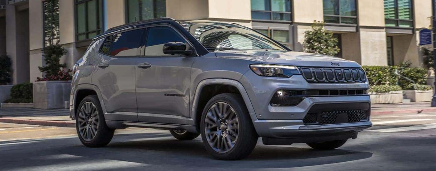 Grey 2022 Jeep Compass driving on a city street