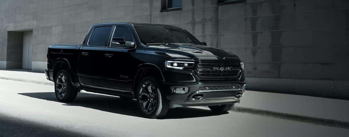 Black 2022 Ram 1500 parked against a concrete building