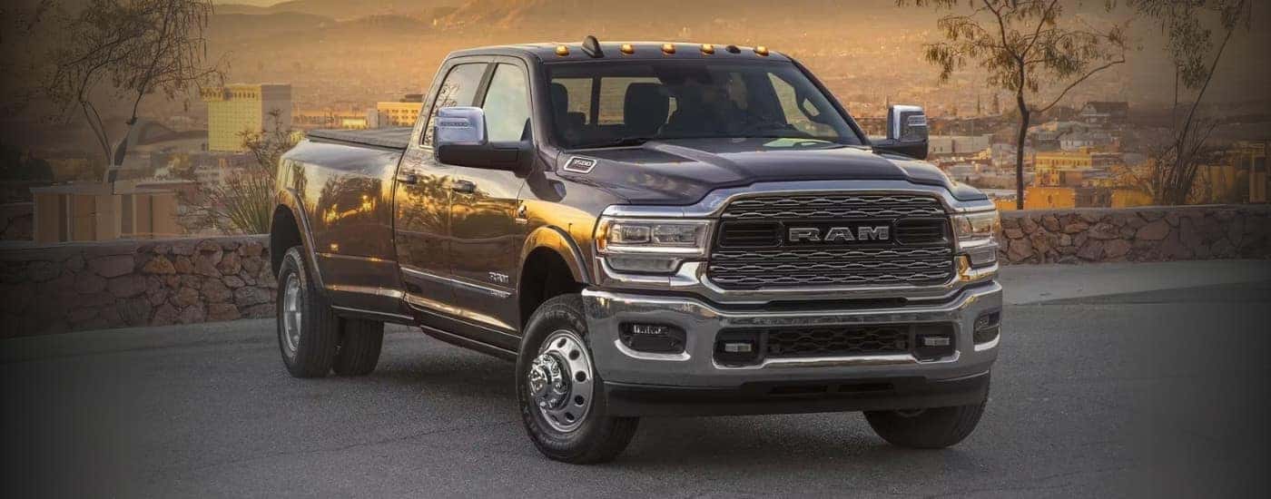 A black 2024 Ram 3500 is shown parked near a stone wall.