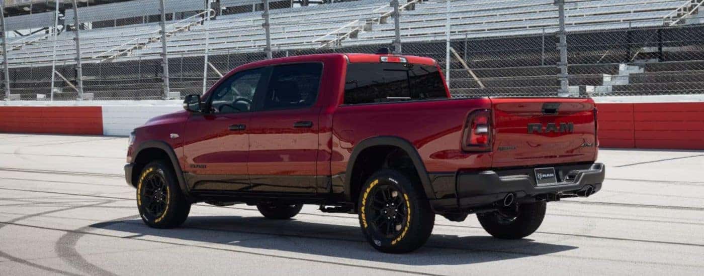 Red 2026 Ram 1500 Rebel parked on a racetrack.
