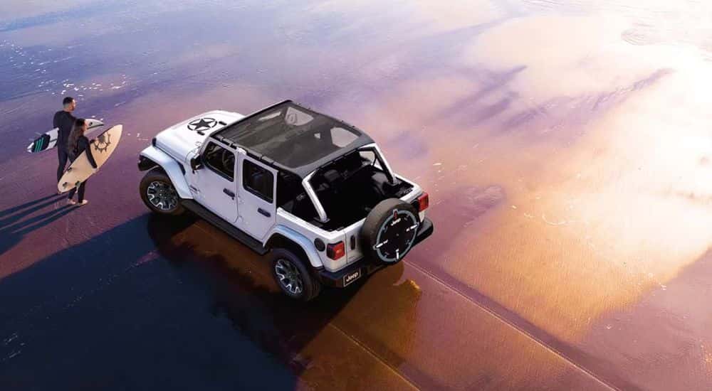 White 2026 Jeep Wrangler from an aerial view on the beach.