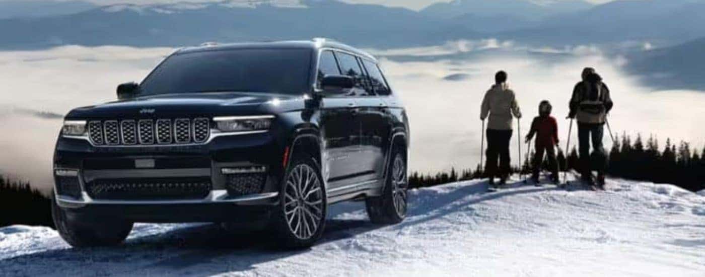 A black 2025 Jeep Grand Cherokee L is shown from the front at an angle.