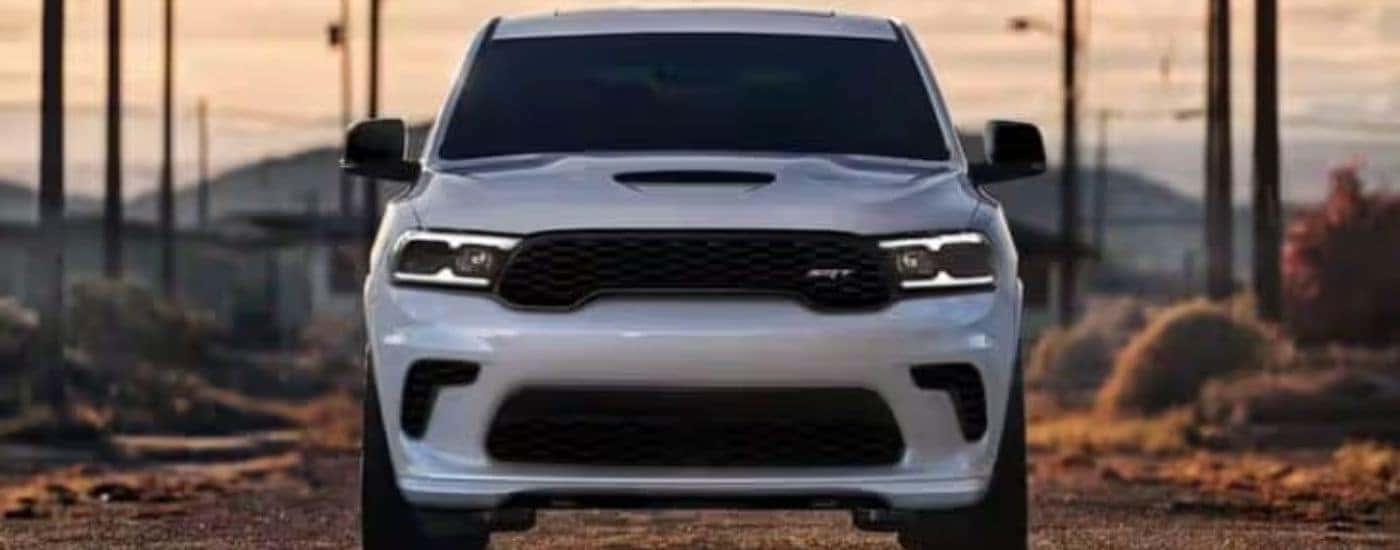 A white 2024 Dodge Durango SRT is shown parked near powerlines.