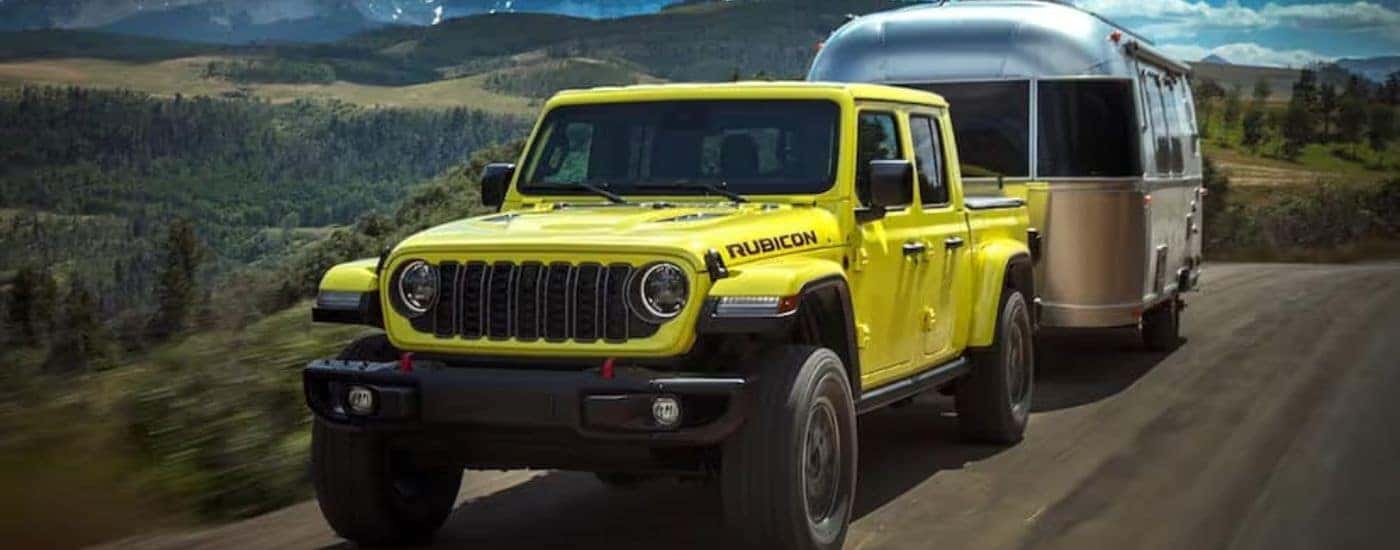 A yellow 2024 Jeep Gladiator Rubicon is shown from the front at an angle.