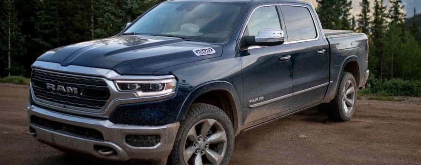 Blue 2022 Ram 1500 Limited parked on a dirt trail.