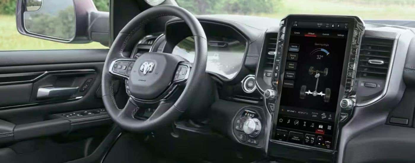 Interior view of a 2026 Ram 1500 steering wheel and touchscreen display.