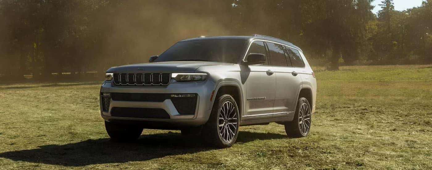 A silver 2026 Jeep Grand Cherokee parked offroad.