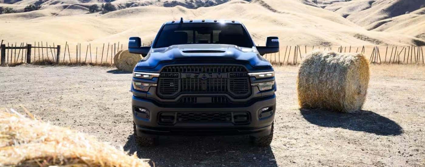 A blue 2026 Ram 2500 shown from the front on a farm.