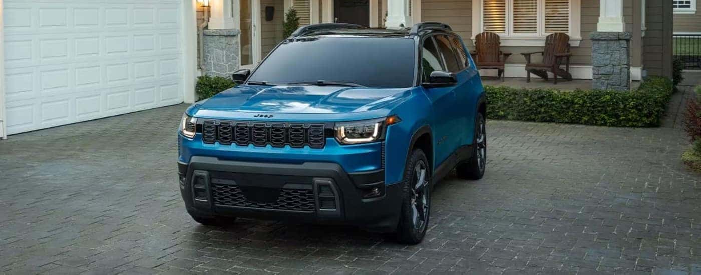 Blue 2026 Jeep Cherokee parked on a driveway