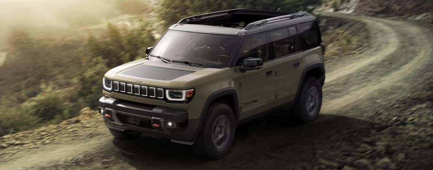 Grey 2026 Jeep Recon driving on a trail