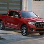 A red 2026 Ram 1500 parked on a driveway.
