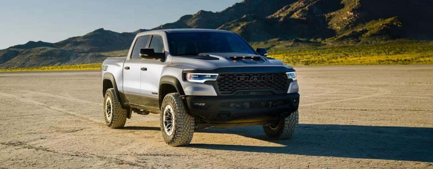 A silver 2027 Ram 1500 RHO parked offroad.