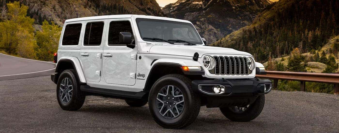 A white 2025 Jeep Wrangler parked off-road
